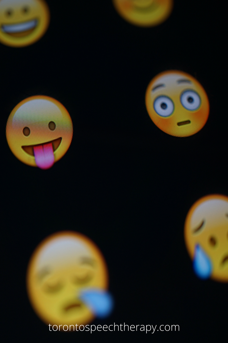 WELL SAID: TORONTO SPEECH THERAPY. A close-up of various expressive emoji faces on a dark screen, including a goofy face with its tongue out, a surprised face, and a crying face. The text torontospeechtherapy.com appears at the bottom.