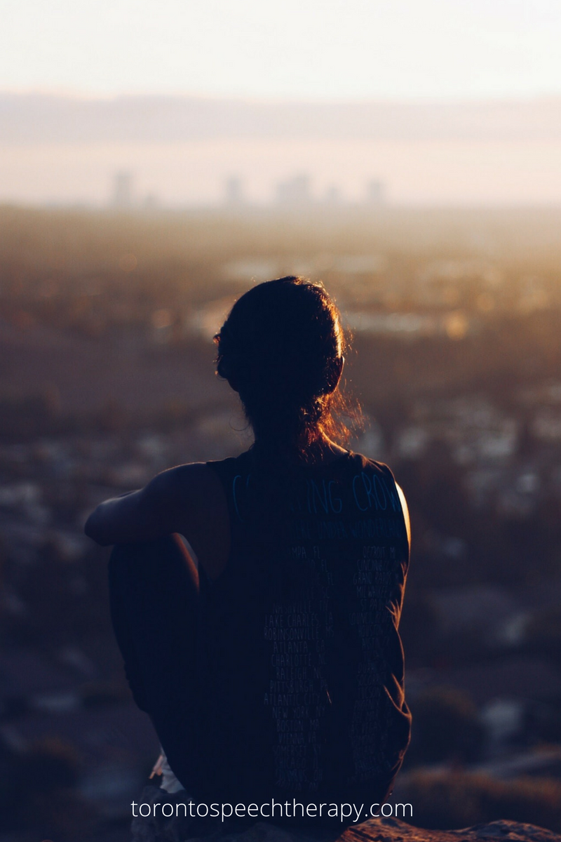 WELL SAID: TORONTO SPEECH THERAPY. A person sits on a hilltop at sunset, gazing out over a cityscape with soft sunlight illuminating their silhouette. The website torontospeechtherapy.com is visible at the bottom.